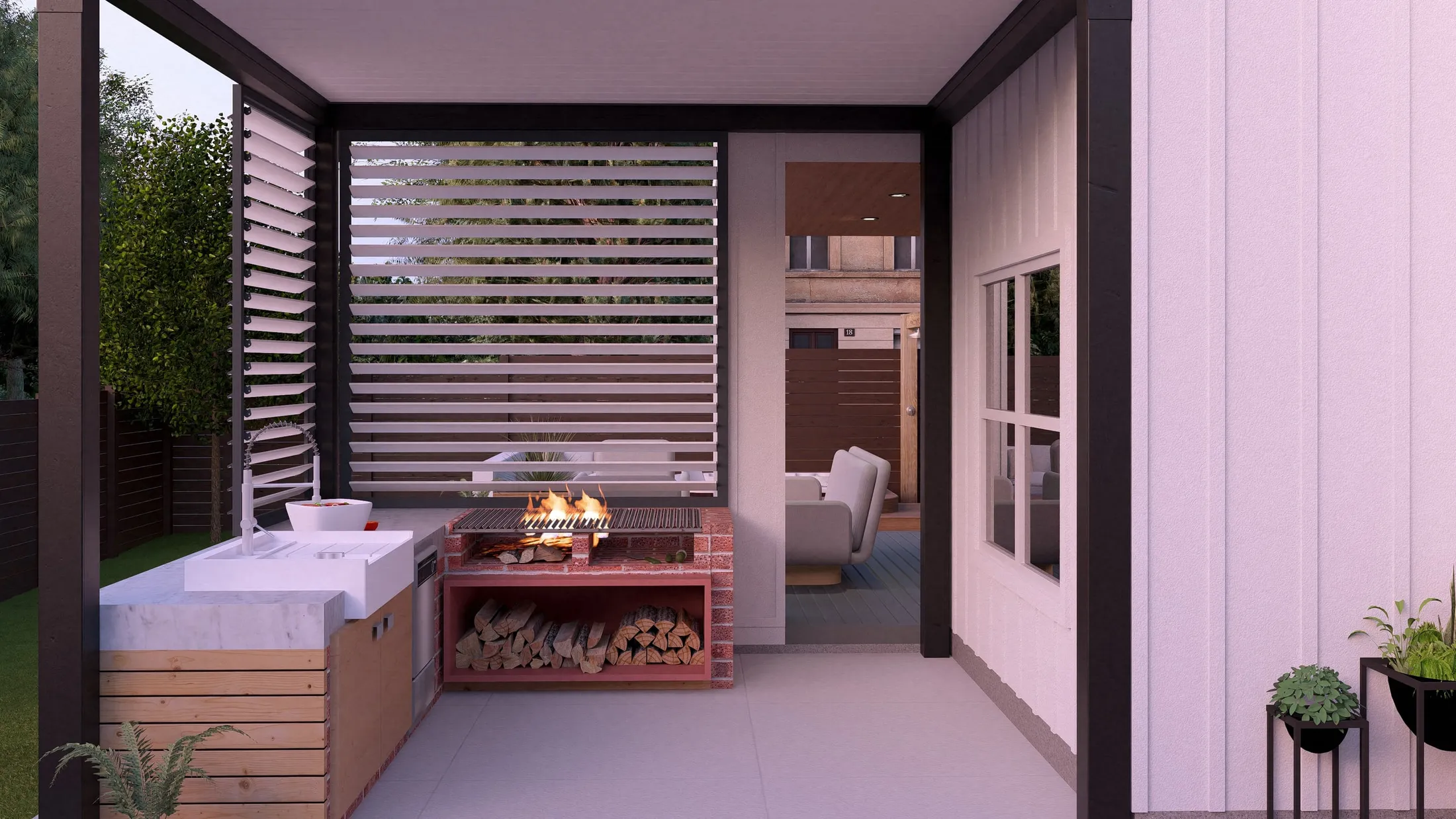 Outdoor kitchen at dusk with the fire lit